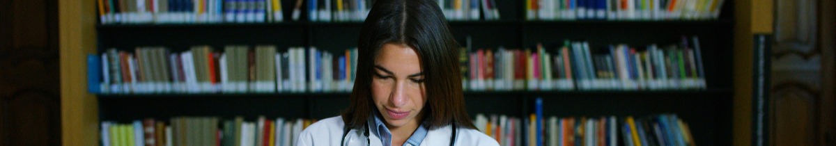 Doctor standing in front of bookshelf