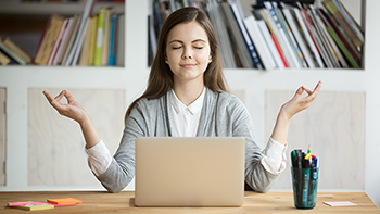 Woman meditating at computer