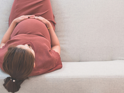 preg woman sitting on couch